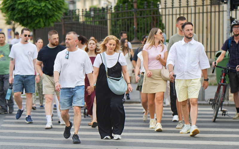 Candid snapshot of people walking on a city street in Bucharest, during a summer weekend